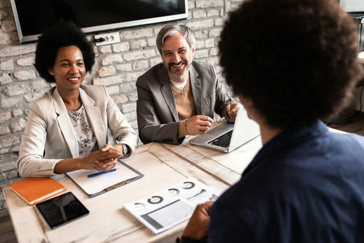 Business recruiters talking with candidate during job interview.