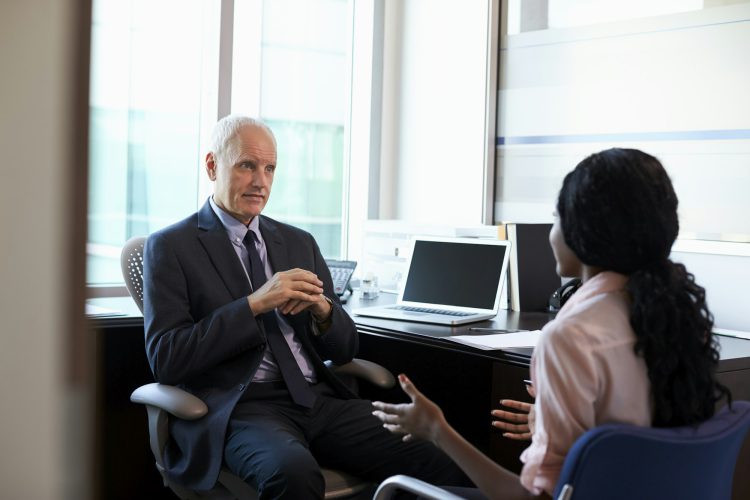 Doctor In Consultation With Female Patient In Office