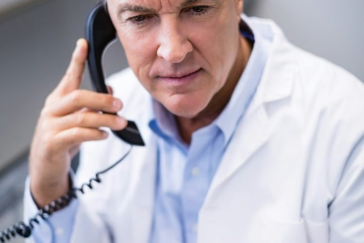 Male doctor interacting on phone